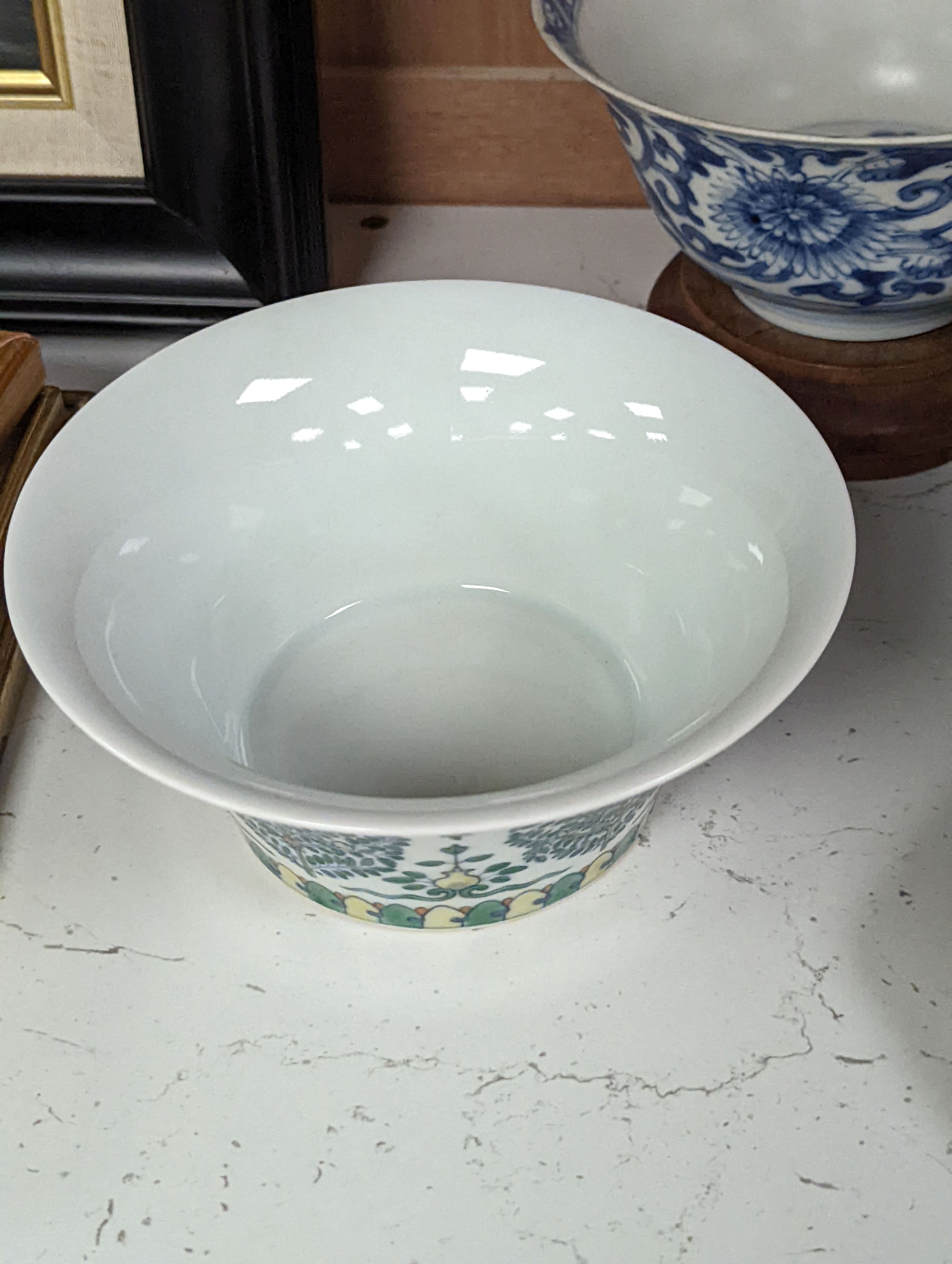 A Chinese blue and white bowl, Kangxi, 15cm. diam., a famille rose teapot stand, Yongzheng, and two doucai bowls